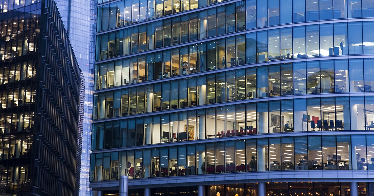 Closeup of curved office building in the evening