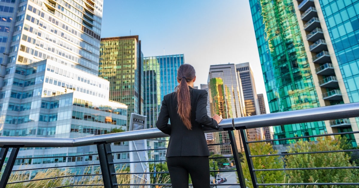 Female leaning over balcony in city center