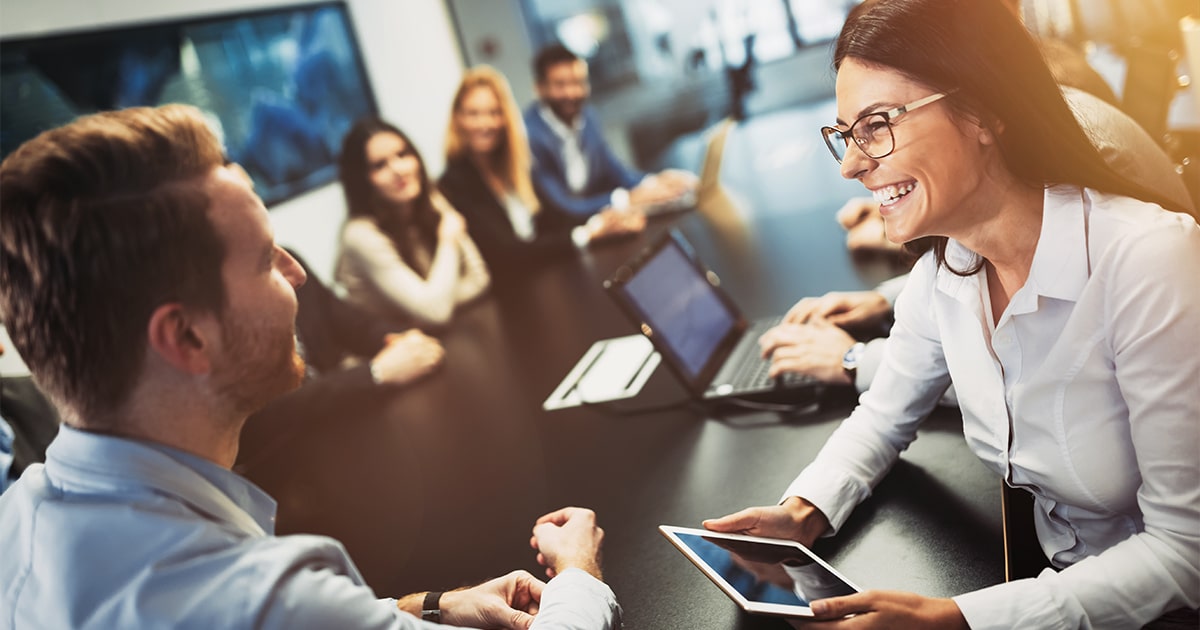 Smiling colleagues in modern meeting room