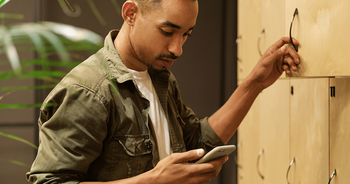 Person at locker checking his phone