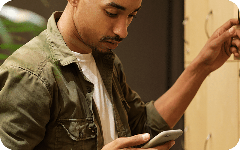 Person at locker checking his phone