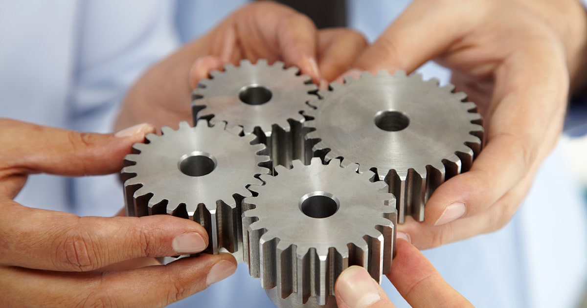 Closeup hands holding gears