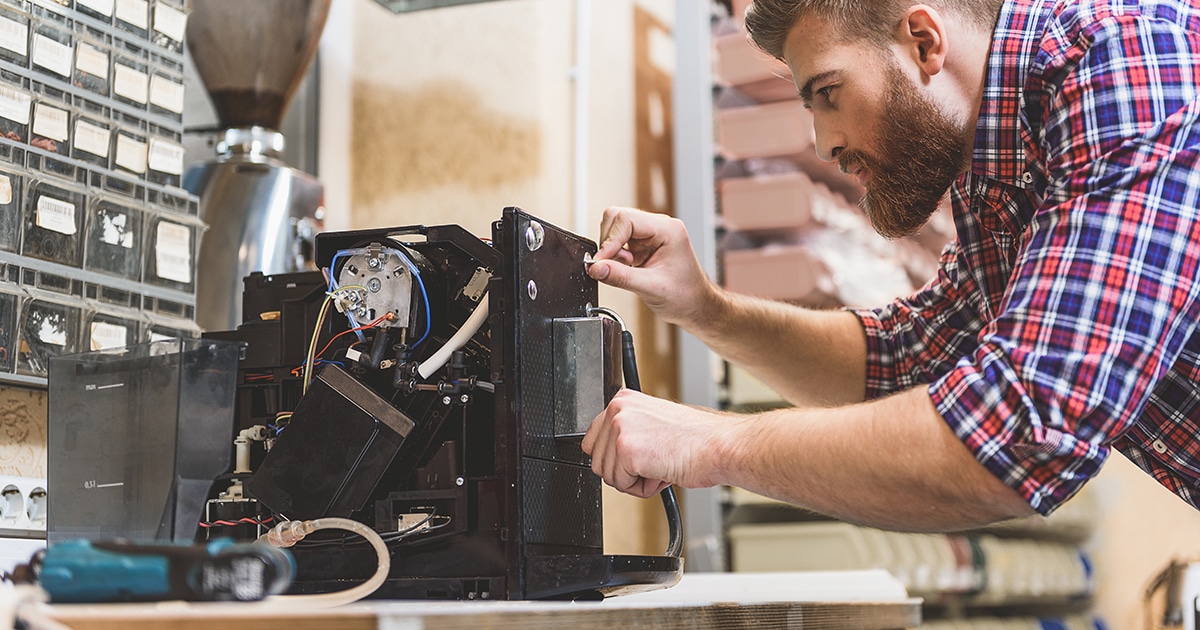 Engineer fixing a coffee machine