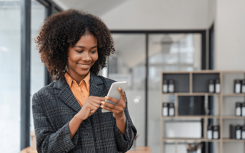 Person smiling and looking at phone